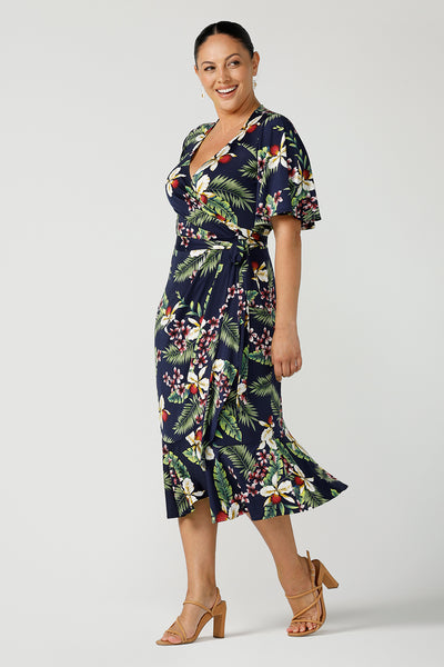 A plus size wrap dress for curvy women in festive Merriment print. Jersey wrap dress in soft jersey fabric with frilly hem and sleeves. Made in Australia size 8 - 24.