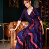 The Fiona Wrap Dress in Jupiter is a vibrant and sophisticated wardrobe essential, showcasing a colourful swirly print that brings energy and movement to every step. Crafted in our luxurious stretch jersey, this classic wrap dress is designed to flatter with a soft A-line skirt that falls gracefully to a midi-length hemline, offering both comfort and timeless elegance.