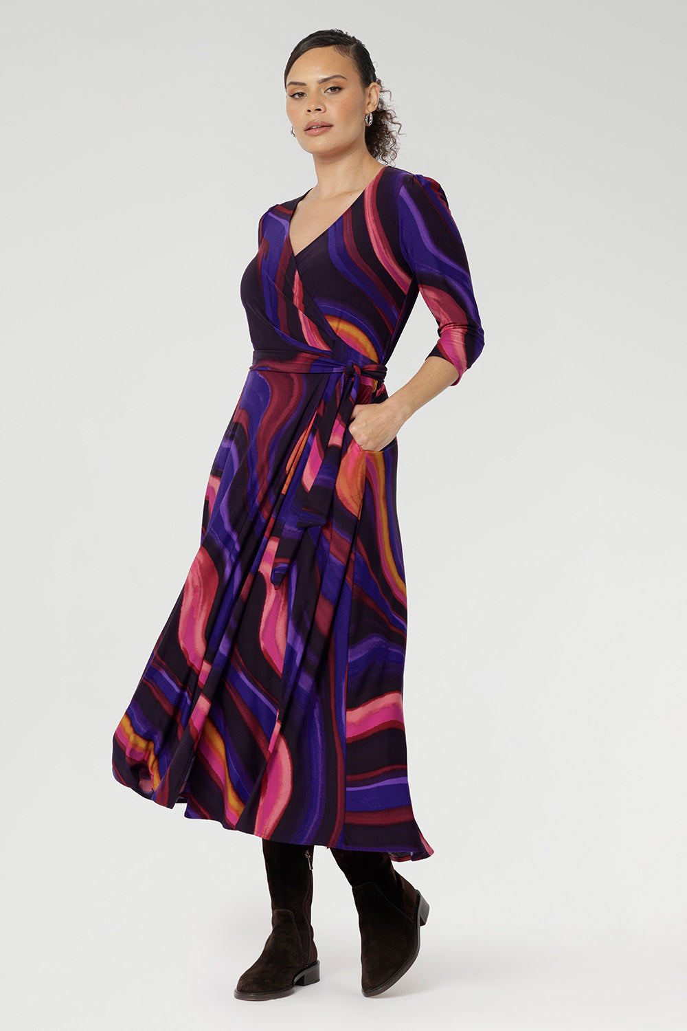 The Fiona Wrap Dress in Jupiter is a vibrant and sophisticated wardrobe essential, showcasing a colourful swirly print that brings energy and movement to every step.