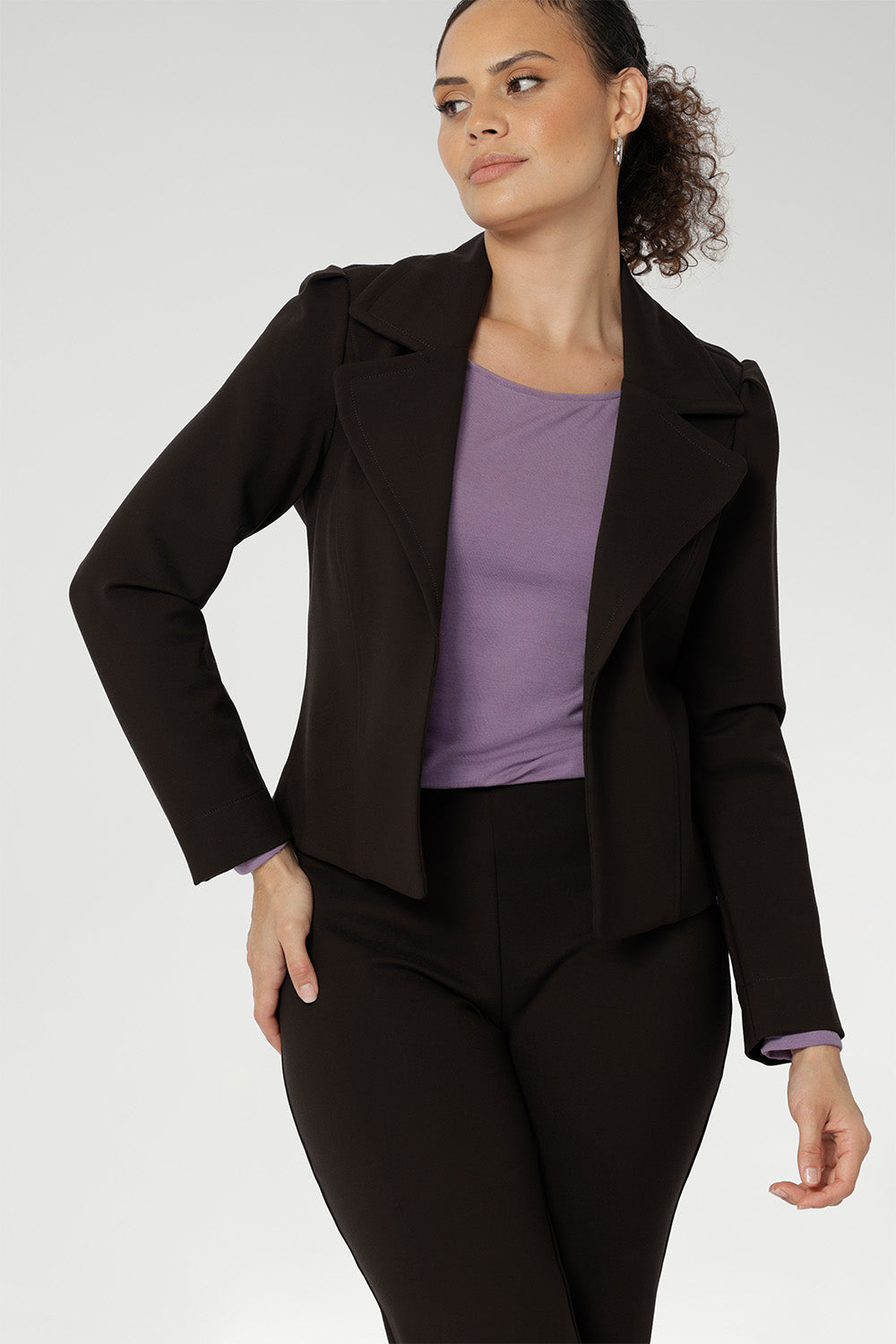 The Garcia Jacket is a modern interpretation of the classic trench, reimagined in a chic cropped silhouette. Expertly crafted from premium dry-touch Ponte jersey fabric with firm stretch, this tailored open-front jacket offers structure, comfort, and ease of movement