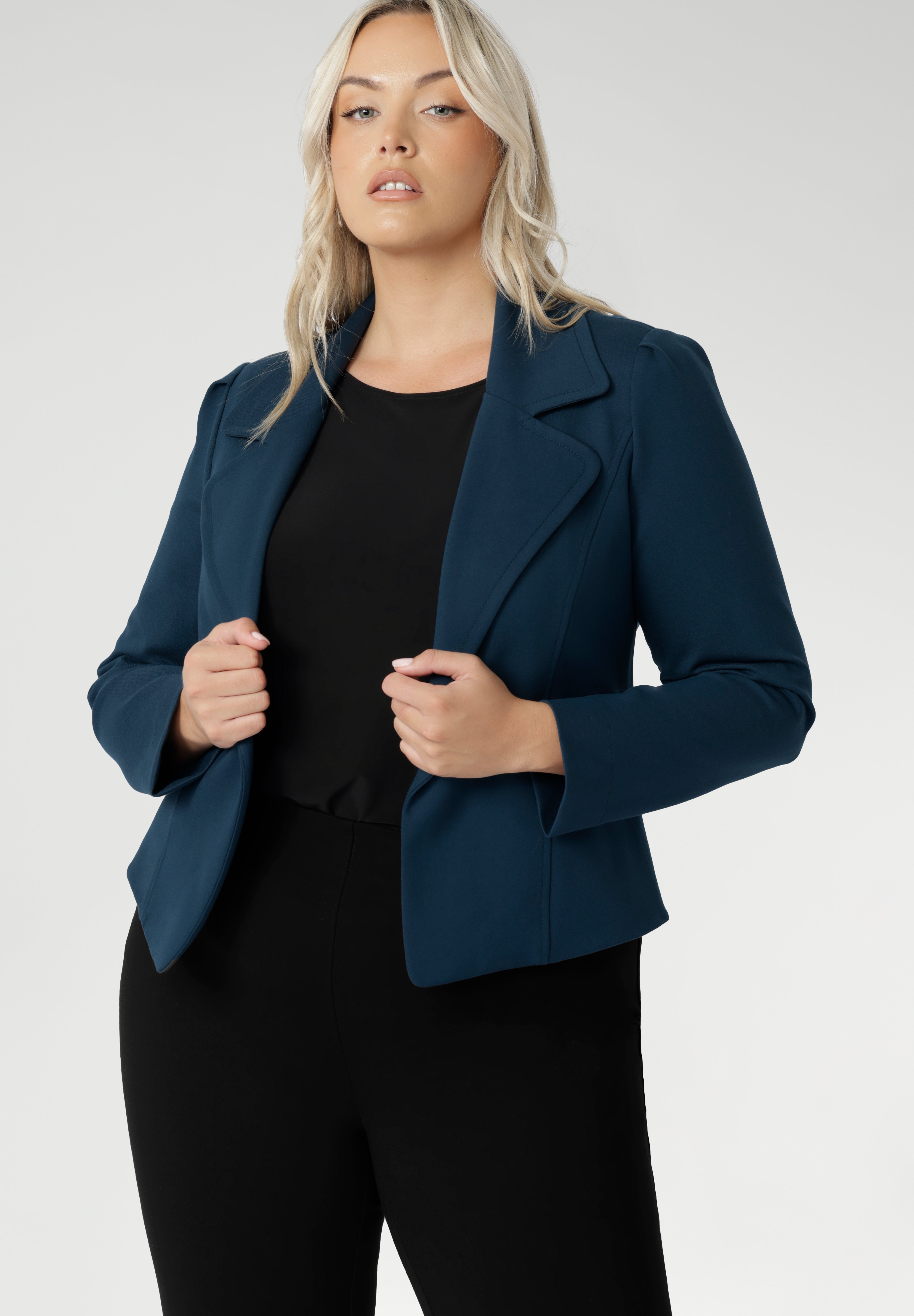 Model wears the Garcia Jacket in Petrol ponte fabric by Australian and New Zealand women's clothing brand, L&F. Featuring collar and notch lapels and long sleeves, this open-fronted jacket is good for corporate wear and casual wear.