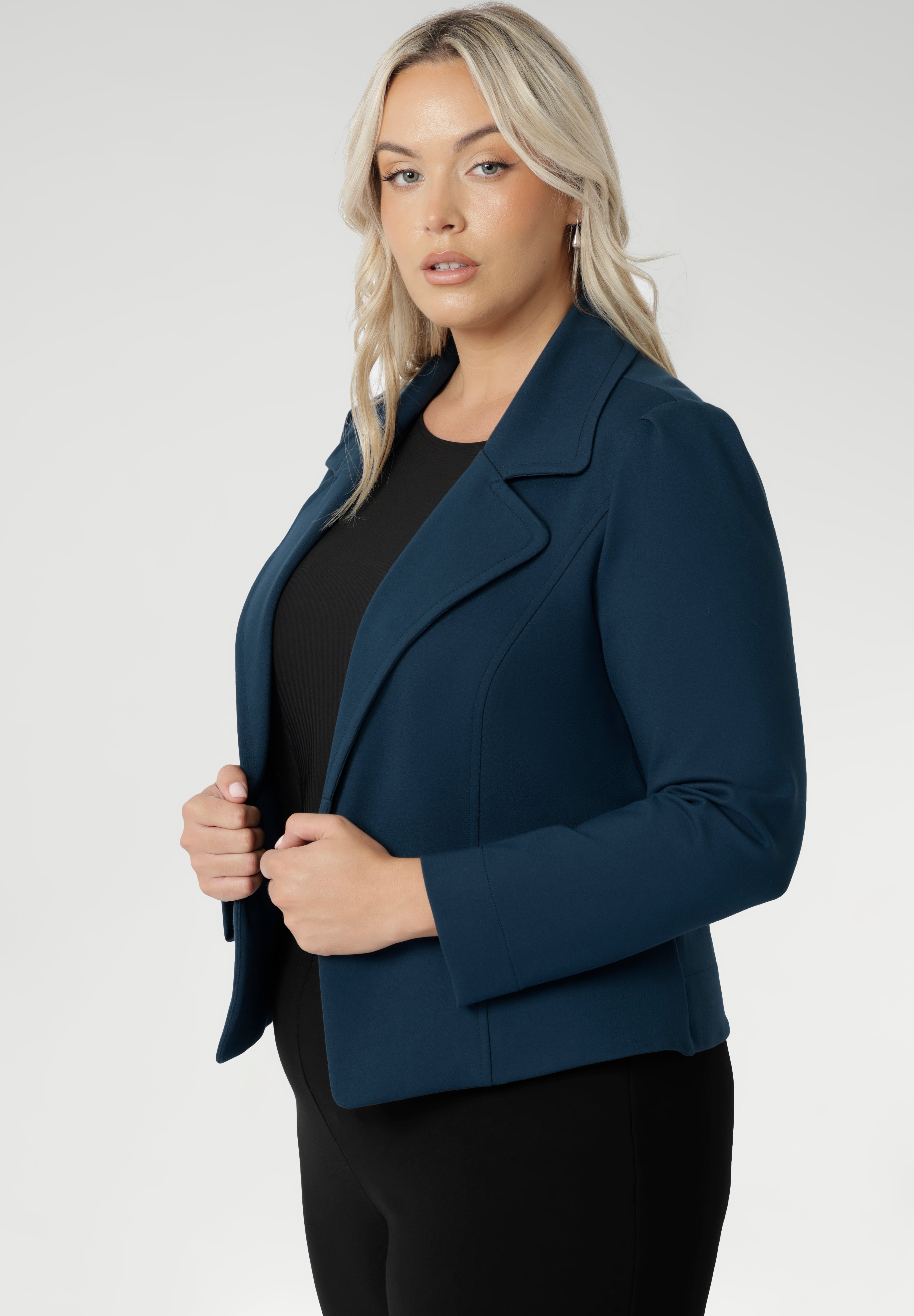 Model wears the Garcia Jacket in Petrol ponte fabric by Australian and New Zealand women's clothing brand, L&F. Featuring collar and notch lapels and long sleeves, this open-fronted jacket is good for corporate wear and casual wear.