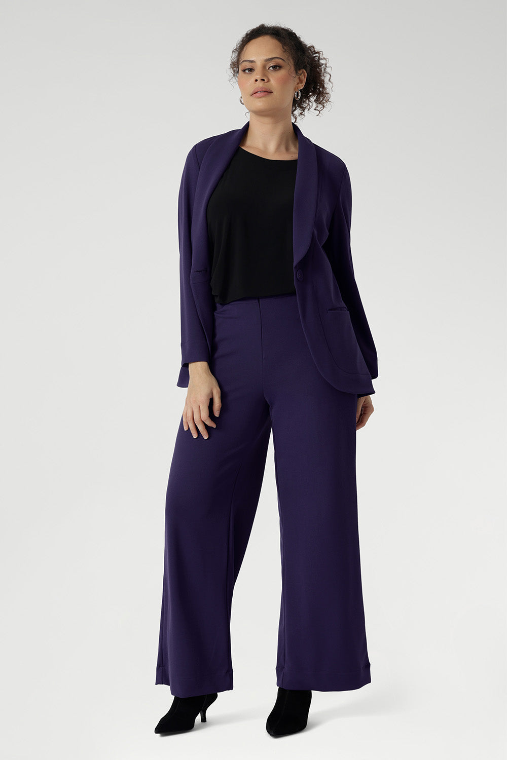 Crafted from our signature dry-touch stretch jersey, this everyday piece features a chic boat neckline and a sleek, streamlined silhouette that layers beautifully. Size 10 model wears her reversible cami under full purple suit for a powerful workwear look.