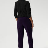 Now available in 2 lengths. A size 10 woman wears the Indi Pant in Amethyst, made from a jersey stretch fabric, with pleat front and cuffed leg opening. Made in Australia for women size 8-24.