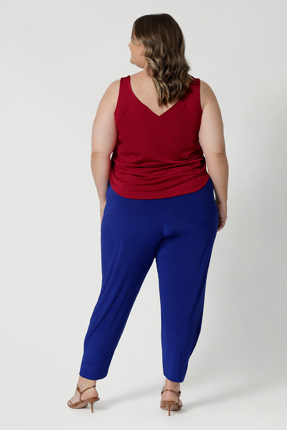 Plus sized model wears travel friendly pants that have soft stretch for added flexibility, ensuring they move comfortably with your body. The fabric's breathable qualities make them ideal for wearing year-round, keeping you cool and comfortable, even in warmer conditions.