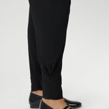 These stylish 7/8 length pants feature single inside seam legs, a tapered leg fit, and ankle cuffs with a tuck detail for a sleek, modern look.