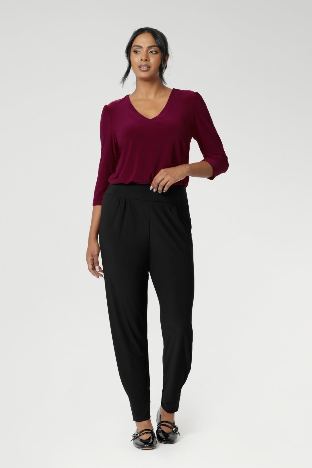 Great pants for travel, these dropped crotch, cropped leg, single seam black pants are made stretchy jersey for ultimate comfort.