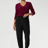 Great pants for travel, these dropped crotch, cropped leg, single seam black pants are made stretchy jersey for ultimate comfort.