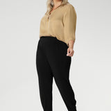These chic 7/8 length pants feature single inside seam legs, a tapered fit, and ankle cuffs with a tuck detail, offering a sleek, modern silhouette. The Indi is the ultimate travel pant, so comfortable that you’ll want more than one pair. Perfectly versatile, it pairs effortlessly with our blazers for a seamless transition from weekend to work. Available in two different heights, designed for both plus-size and petite women.