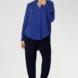 Indi is the perfect travel pant that feels so comfortable to wear, that you'll end up getting more than one pair. Can be styled with Tencel tops for elevated workwear style. Available in two different heights. These stylish 7/8 length pants feature single inside seam legs, a tapered leg fit, and ankle cuffs with a tuck detail for a sleek, modern look.