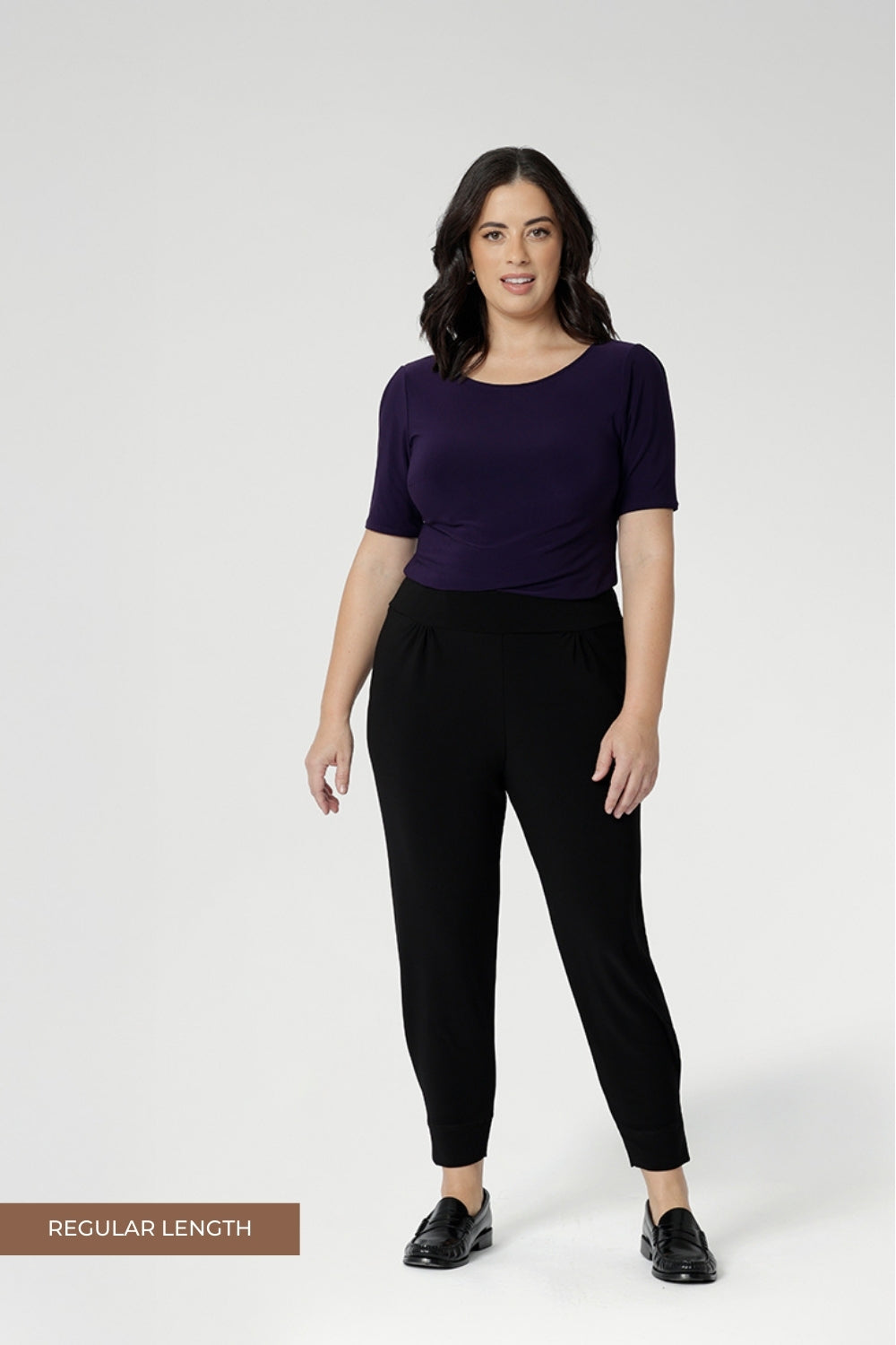 Petite height model wears travel pant that feature dropped crotch & tapered legs. Model is size 10. Travel ready pants made from stretchy jersey for ultimate comfort. Made for Australian and New Zealand women, by clothing brand Leina & Fleur. Now available in sizes 8-24 and in 2 lengths.