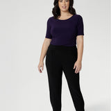 Petite height model wears travel pant that feature dropped crotch & tapered legs. Model is size 10. Travel ready pants made from stretchy jersey for ultimate comfort. Made for Australian and New Zealand women, by clothing brand Leina & Fleur. Now available in sizes 8-24 and in 2 lengths.