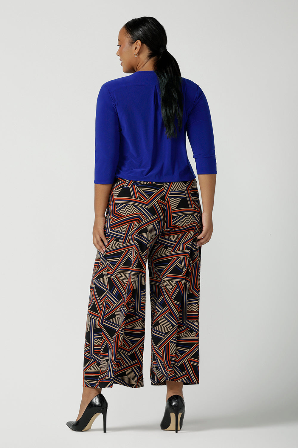 Back view of a size 16 woman wears the Dany Culotte in Trixie, a printed Jersey work pant with a geometric pattern. Wide leg with functional pockets and wide waistband. Cropped length and petite height friendly. Made in Australia for women size 8 - 24.