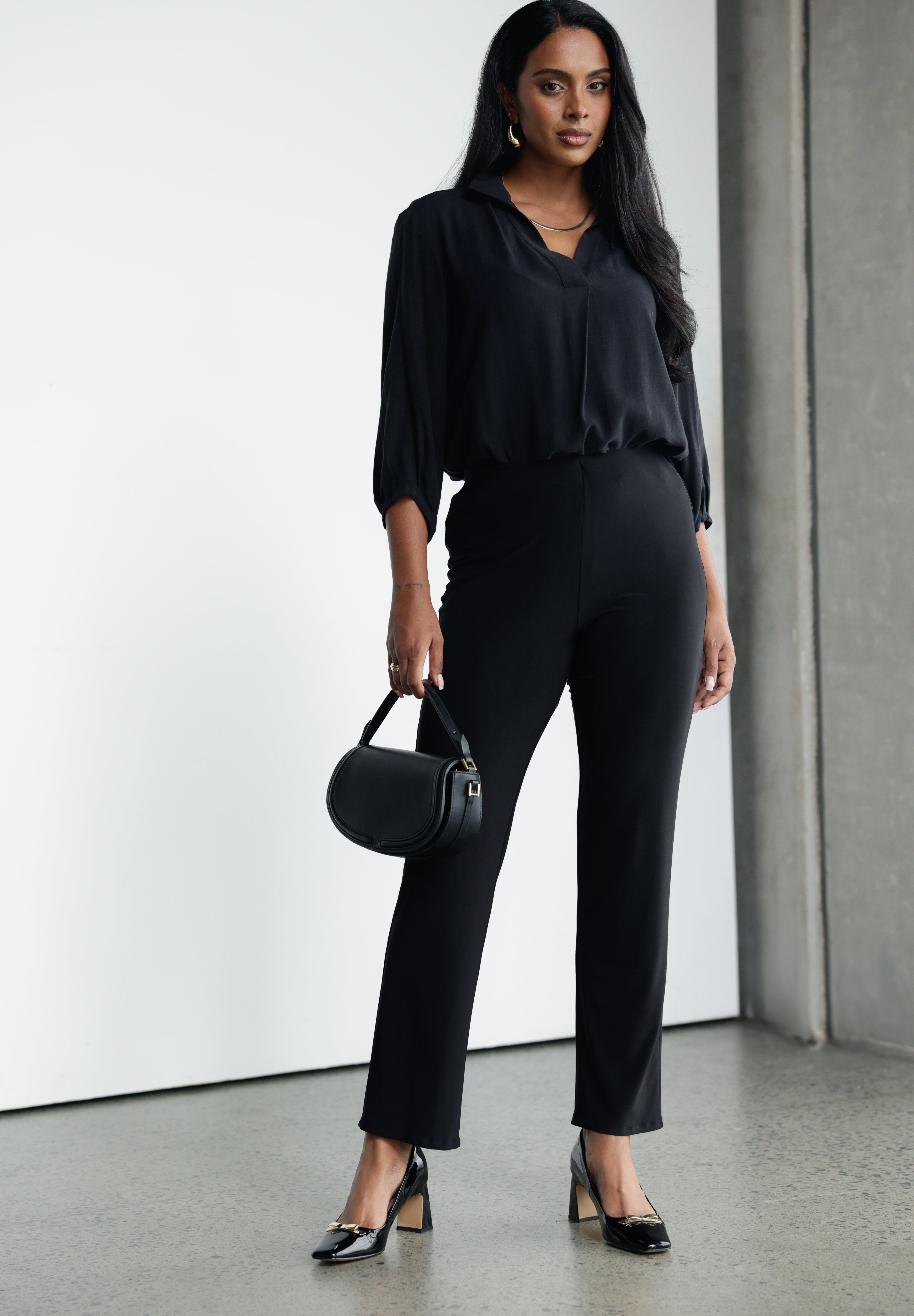 These classic black straight-leg pants are a timeless wardrobe essential, offering both style and comfort for a range of occasions. Made from soft-touch black jersey fabric, they provide a smooth, luxurious feel against the skin while offering breathability and flexibility for all-day wear.