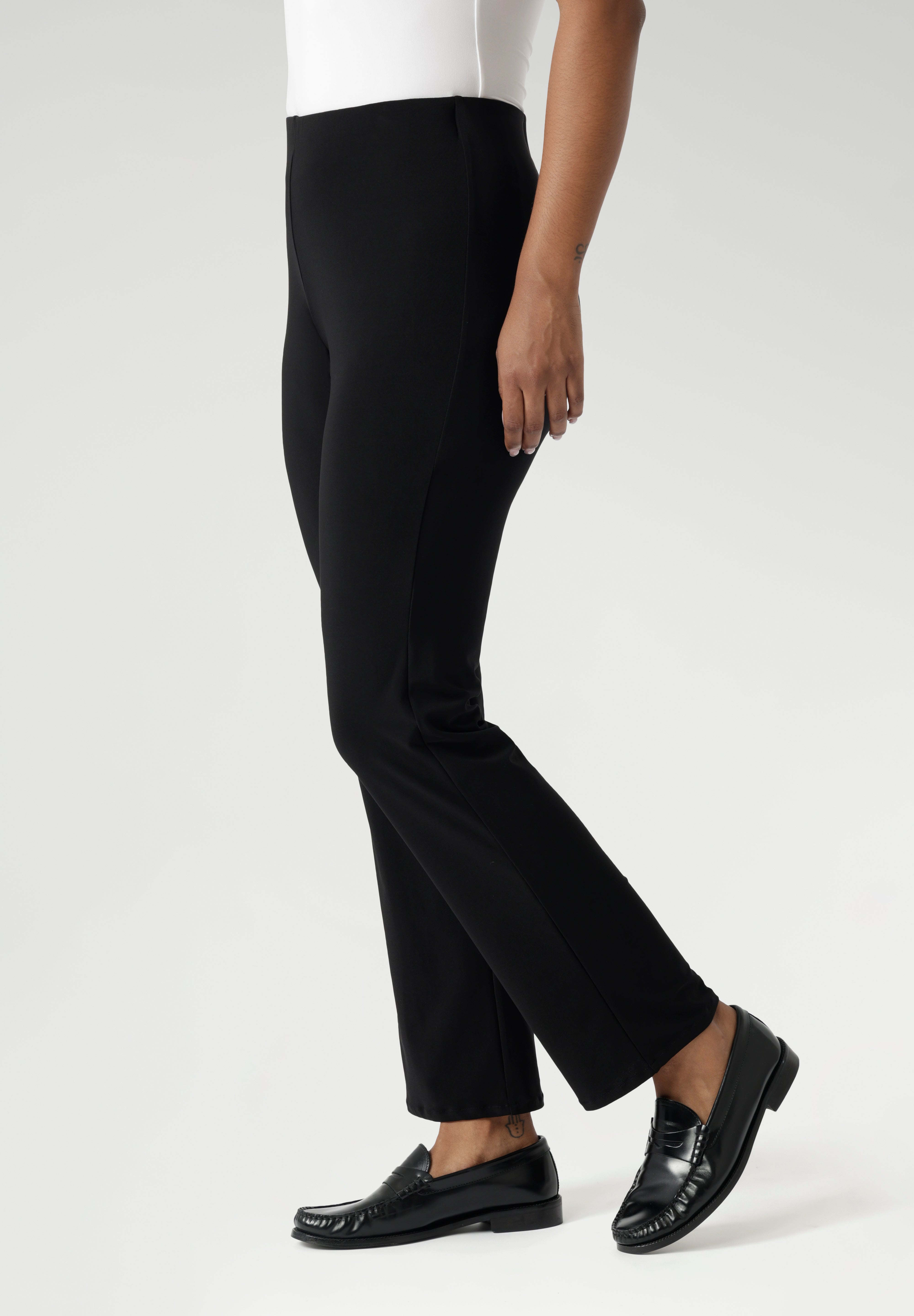 The straight-leg cut is both flattering and versatile, creating a clean, tailored silhouette that works for both casual and elevated looks. Size 12 model pairs black pants with white top & silver sneakers for a casual look.
