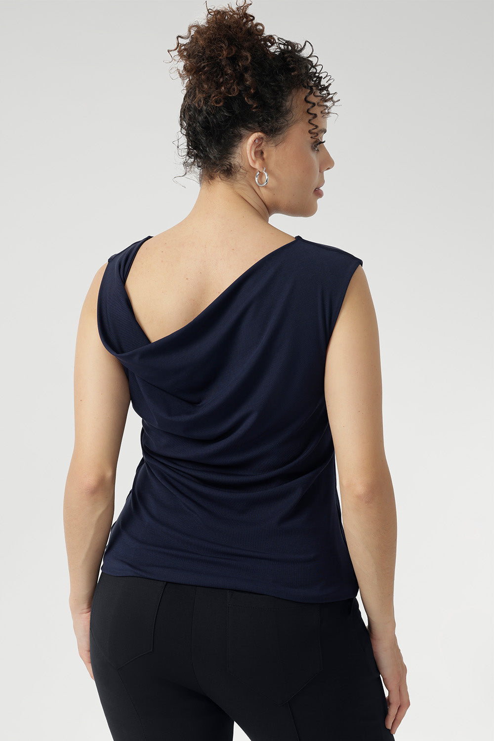 Featuring a double-layer front and back for a smooth, flattering fit, the Jordan Top blends modern style with timeless versatility. Proudly designed and made in Australia. Size 10 model features asymmetrical cowl neckline back facing, dropped across her back.