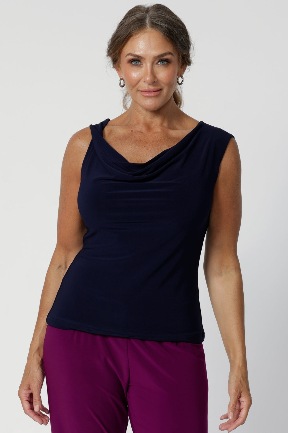 Sleeveless top can also be flipped to reveal the boat-neck style or cowl neck offering for a more open and structured silhouette. Available in navy, black and magenta. Workwear top can easily be paired with both plain pieces and prints. Available in sizes ranging from 8-24. Jordan Top is a wardrobe must-have, offering two stunning looks in one. Shop now at Leina & Fleur.