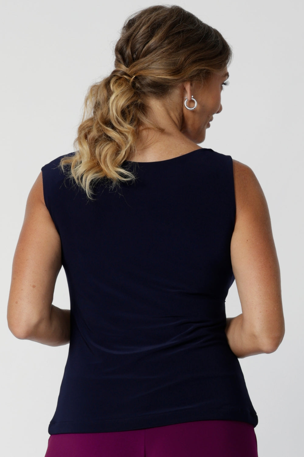 The Jordan Top is the perfect workwear piece, designed with the modern woman in mind. This versatile sleeveless top can also be flipped to reveal the boat-neck style. Model wears navy top in size 12.