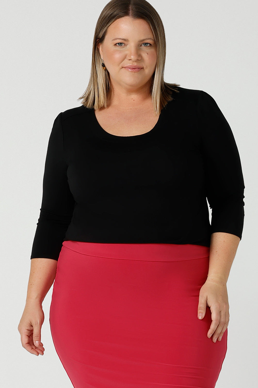 Jules in black bamboo with a scoop neckline and 3/4 sleeve. In soft black bamboo, this top is the perfect corporate casual workwear top. Designed and made in Australia for Leina & Fleur sizes 8 - 24. Styled on a curvy size 18 woman. 