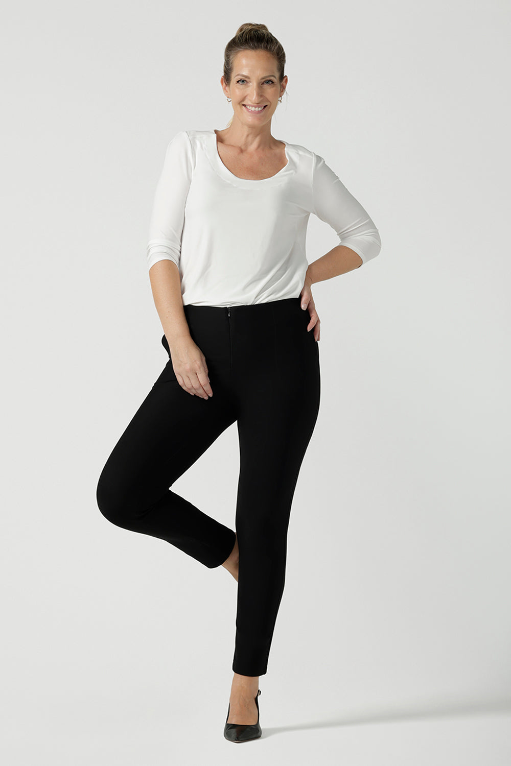 Size 10 woman wears the Jules Top in Vanilla. A 3/4 sleeve comfortable jersey top in vanilla white with a scoop neckline. Comfortable easy care jersey made in Australia for women size 8 - 24. Black ponte Brooklyn pants. 