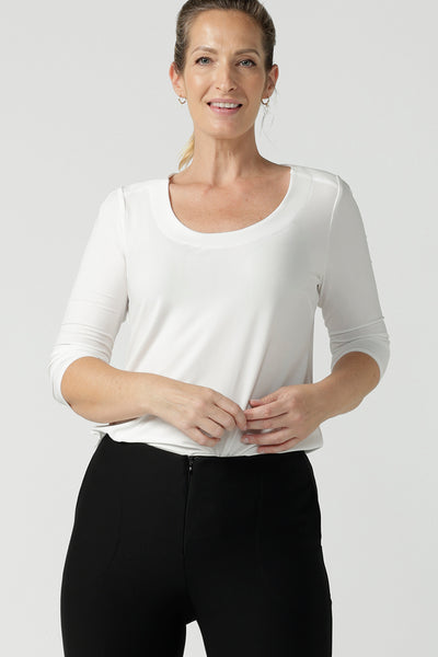 Size 10 woman wears the Jules Top in Vanilla. A 3/4 sleeve comfortable jersey top in vanilla white with a scoop neckline. Comfortable easy care jersey made in Australia for women size 8 - 24. 