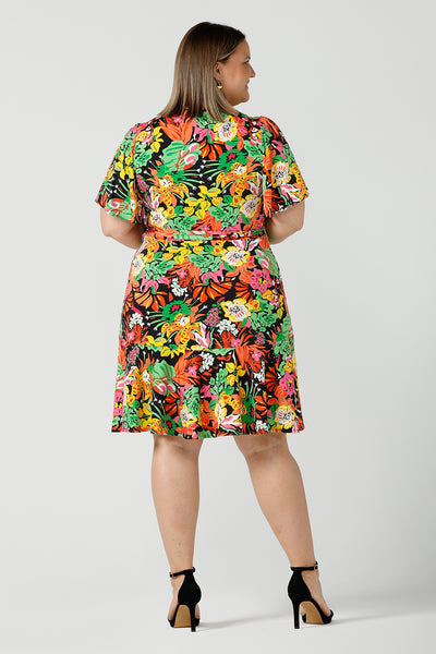 Back view of a close up of a size 18 curvy woman wears a colourful jersey wrap dress in the Cancun print. A petite-height-friendly wrap dress with flutter sleeves and playful ruffle hem, twirl away the summer in the Julie Dress in Cancun. Made in Australia for sizes 8 -24