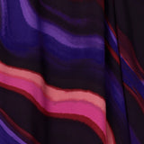 Close up swatch image of the vibrant and colourful swirly print named jupiter that was used to design an Australian Made wrap dress and fixed wrap top that brings energy and movement to every step. Crafted in our luxurious stretch jersey, these styles are available in sizes 8-24.