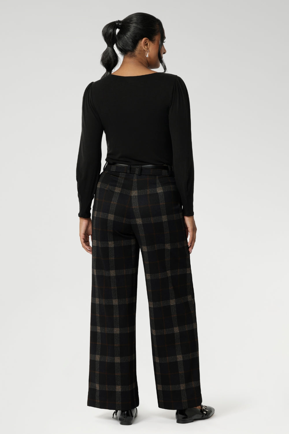 The Kade Pant forms part of the Cocoa Plaid collection—a sophisticated check in rich navy and graphite tones. A wide-leg cut that flatters and elongates. A tailored waistband with a fly front and hook-and-bar closure offers a smooth, secure fit, while belt loops, back darts, and side front pockets add classic suiting details with a modern edge.