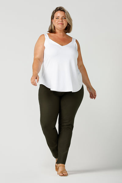 a plus size 18, fuller figure woman wears a bamboo cami with olive pants. In white bamboo jersey, this top is a good addition to your capsule wardrobe for weekend wear, work and travel. Shop Australian-made dresses online is sizes 8 to 24.