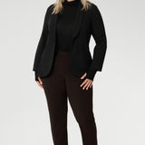 Perfect for layering or wearing on its own, the Kean Top is ideal for everything from casual outings to travel and workwear. Available in inclusive sizes 8 to 24, this versatile piece is as practical as it is polished—making it a must-have for your transitional wardrobe. Size 18 model wears Kean Top black with brown pants and a black blazer.