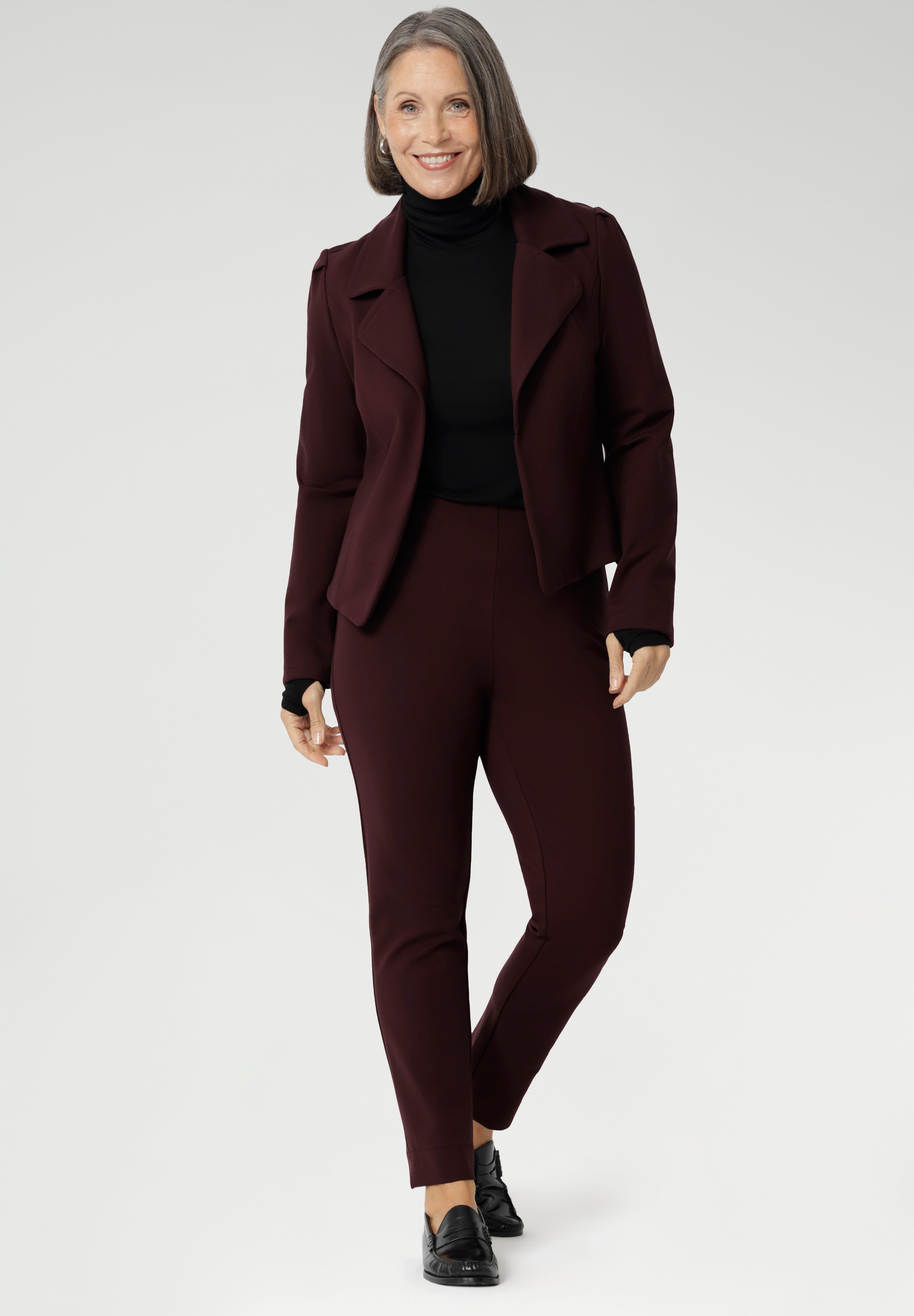 Introducing the Kean High Turtleneck Top from our Light Layers collection—a stylish and functional wardrobe essential designed to keep you comfortable as the seasons change. Made from luxurious blend of lightweight TENCEL™ and wool, offering breathable warmth without the bulk. Over 50s model wears Kean Top with burgundy suiting and black loafers for warm and elevated corporate look.