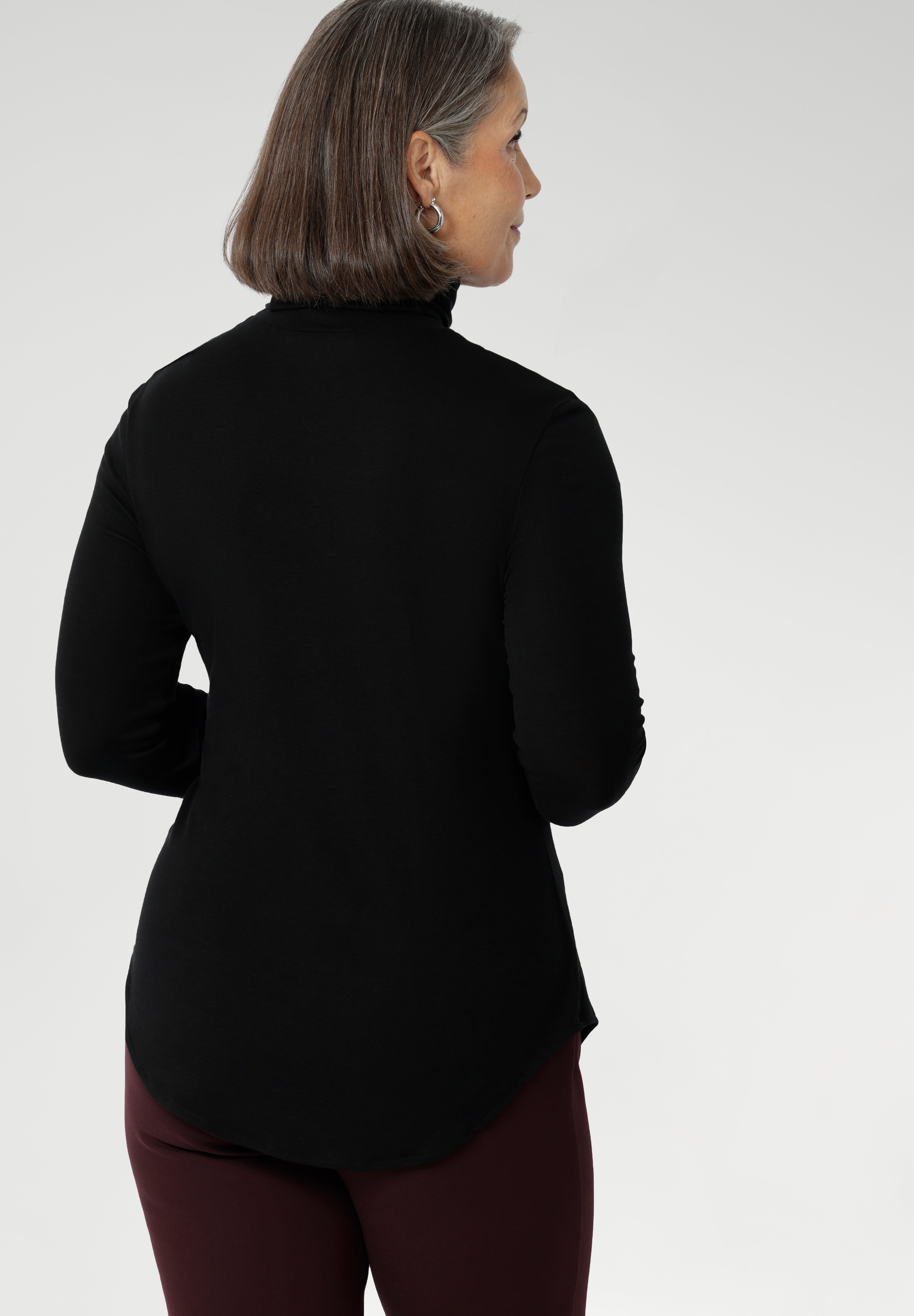 This black long-sleeve top is crafted from a luxurious blend of lightweight TENCEL™ and wool, offering breathable warmth without the bulk.