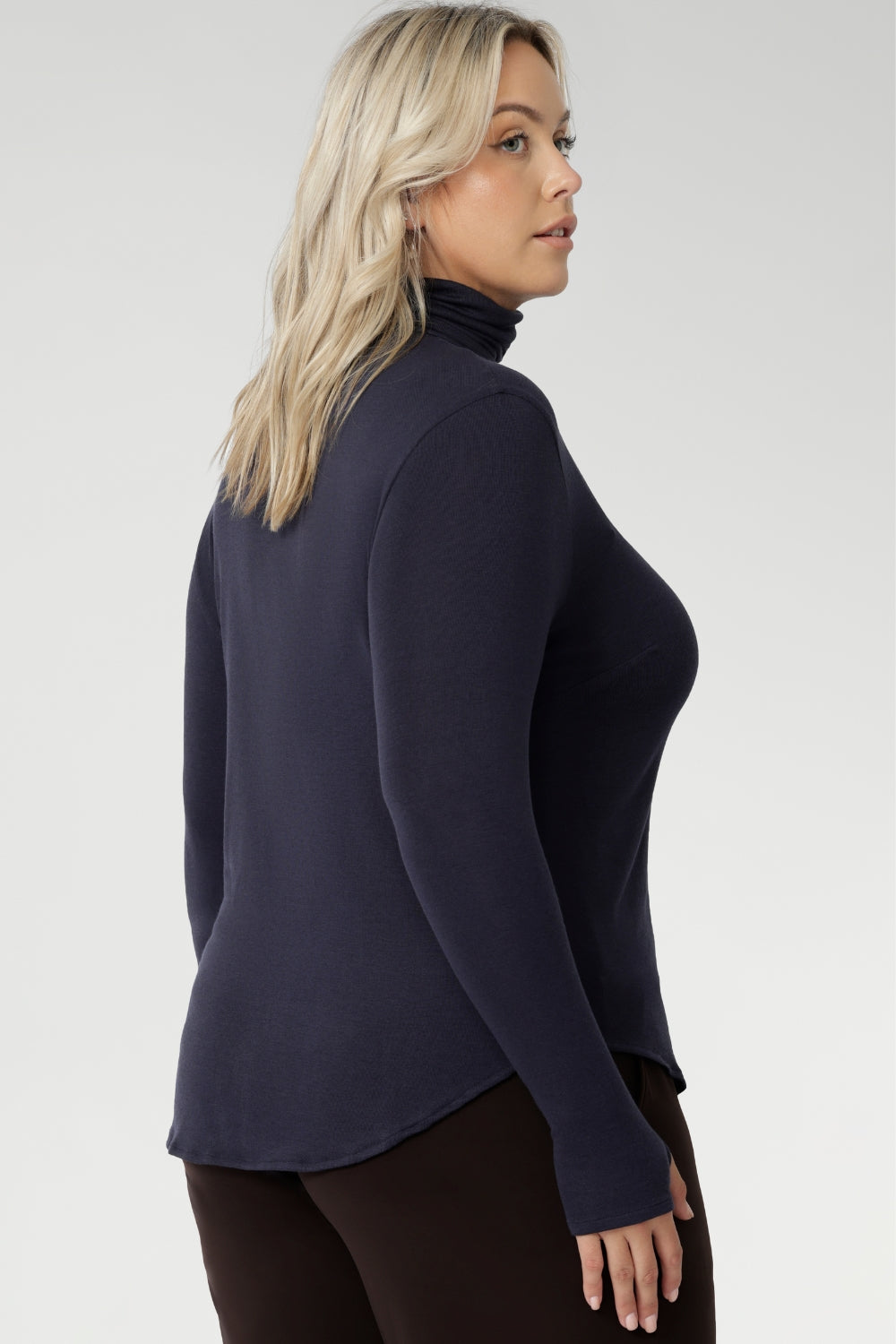 Introducing the Kean high turtleneck top from the Light Layers collection, a stylish and functional piece designed to elevate your wardrobe as the seasons cool. This long-sleeved top features convenient thumb holes for added comfort and warmth. Crafted from lightweight, warm tencel wool fabric.