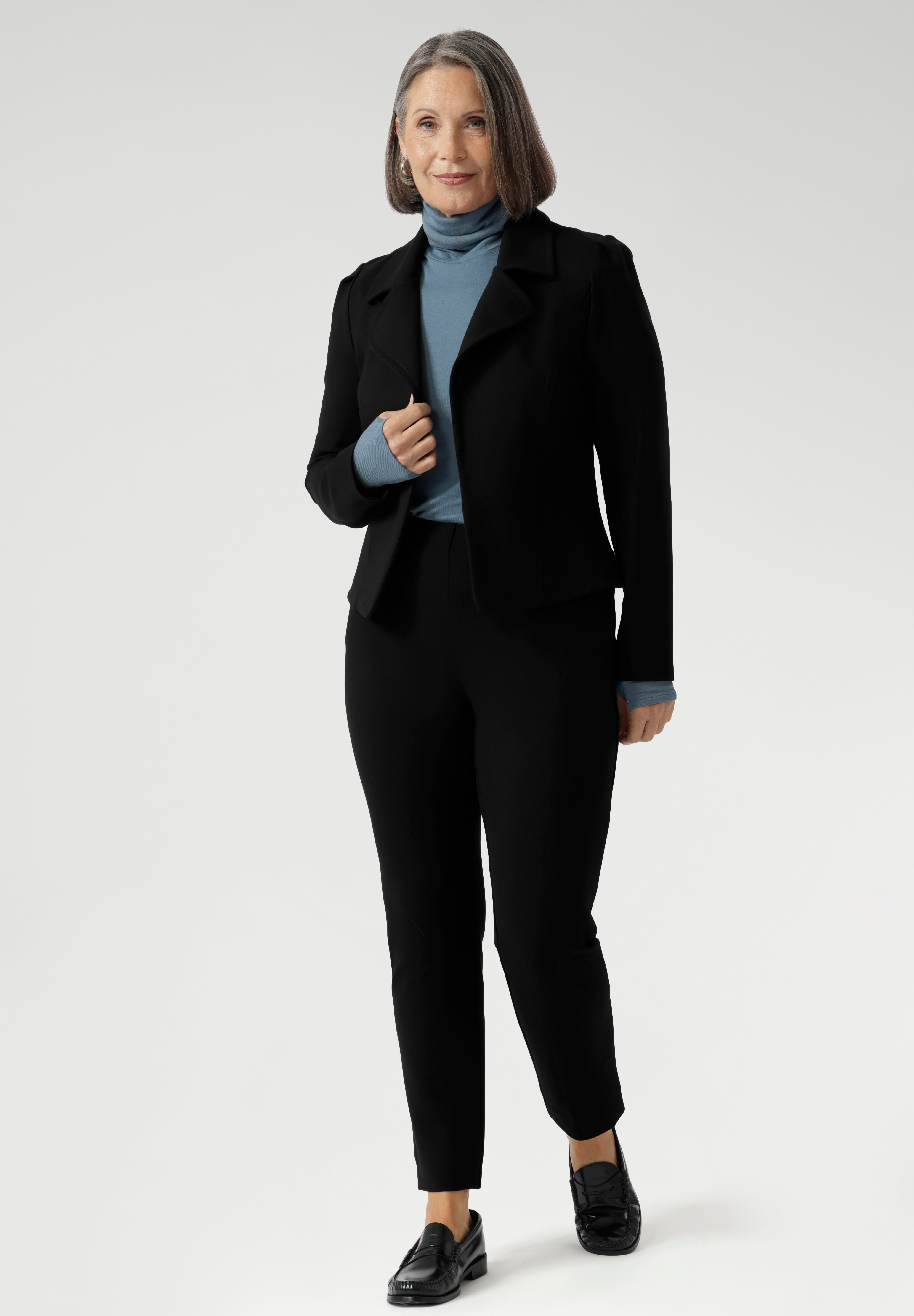 Introducing the Kean high turtleneck top from the Light Layers collection, a stylish and functional piece designed to elevate your wardrobe as the seasons cool. This long-sleeved top features convenient thumb holes for added comfort and warmth. Made from a blend of stretchy Tencel wool fabric, it offers both flexibility and coziness, making it the perfect layering piece for cooler weather.