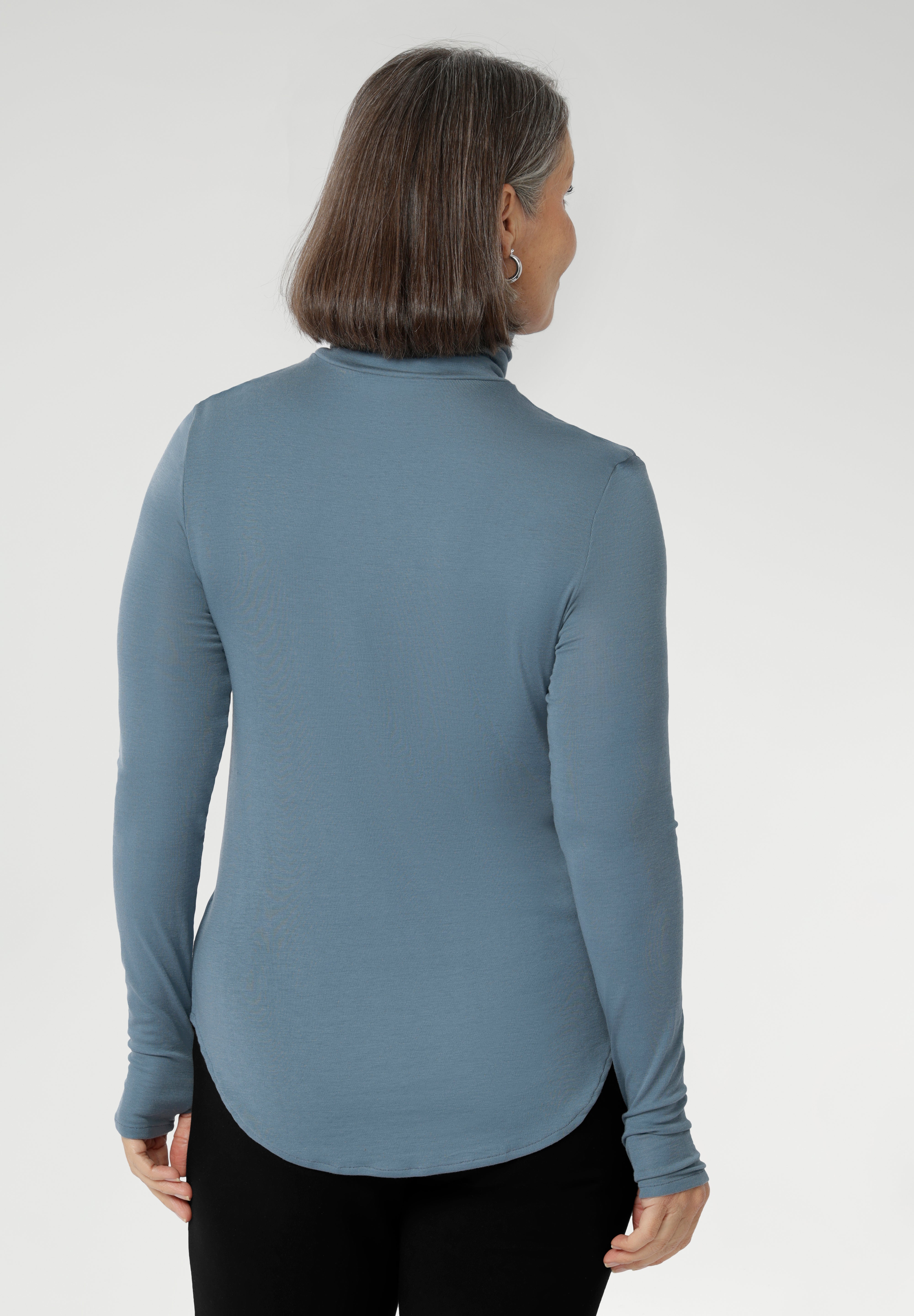 This long-sleeved top features convenient thumb holes for added comfort and warmth. Made from a blend of stretchy Tencel wool fabric, it offers both flexibility and coziness, making it the perfect layering piece for cooler weather.