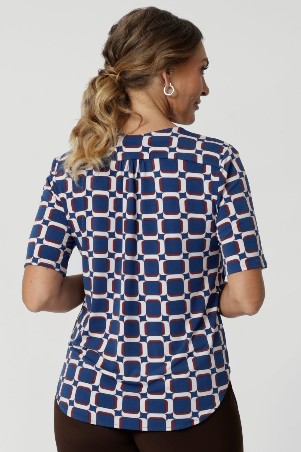 The shirttail hemline gives the top a polished, modern finish, whether tucked into high-waisted pants or skirts for a professional look or worn untucked for a more relaxed vibe. Available in sizes 8-24, the Kodi Top in Ocean is designed to flatter a variety of body types and pairs perfectly with our blazers for seamless style from office to evening.