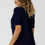 Subtle soft gathers at the front under the shoulder yoke and at the centre-back create a gentle, feminine shape, enhancing the top's overall fit without compromising on comfort. The shirttail hemline provides a clean, polished finish, making it easy to tuck in or leave out depending on your style preference.