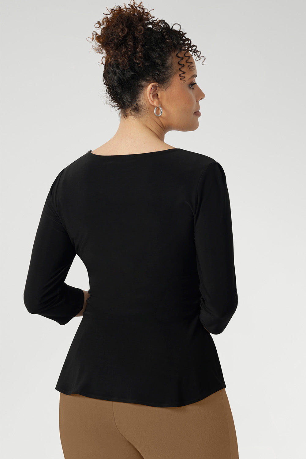 Back view image of fixed wrap top made in Australia for women size 8-24. The perfect work to weekend top in comfortable and easy care jersey. Peplum top works perfectly with pants and skirts to create effortless workwear styling.