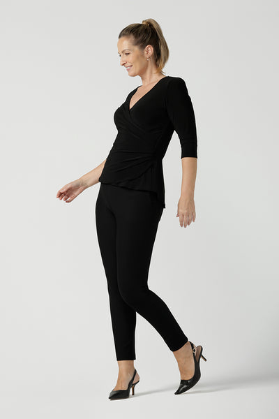 Size 10 woman wears the Kyle top in Black soft jersey. A soft wrap top made in Australia for women size 8 - 24. The perfect work to weekend top in comfortable and easy care jersey. Made in Australia for women size 8 - 24.