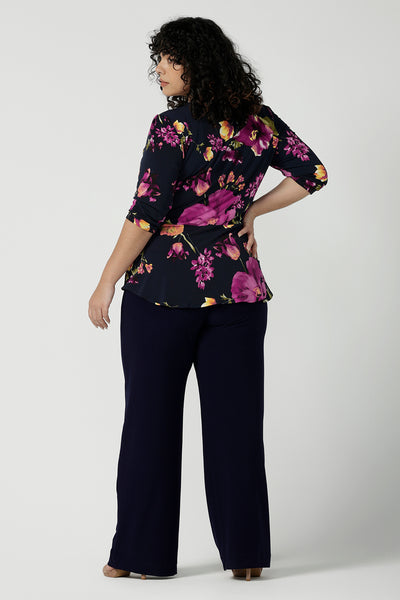 Back view of a size 18 woman wears the Celeste Top and Navy monroe pant. A beautiful fixed wrap top with a peplum and shoulder sleeeve tuck with 3/4 sleeves. Made in Australia for women size 8 - 24.
