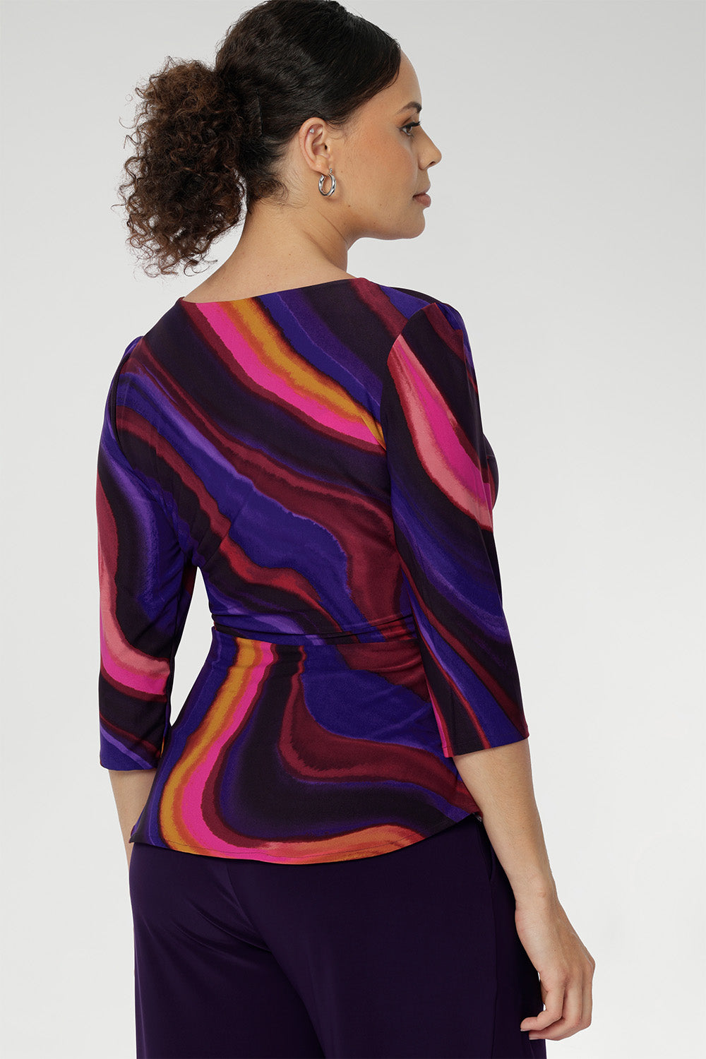 The Kyle Top is tailored with a flattering wrap bodice and 3/4 length sleeves for refined coverage. A soft peplum waist seam enhances the silhouette with subtle structure and femininity. Wear it loose for a graceful drape or tuck it into high-waisted pants for a more defined, office-ready look.