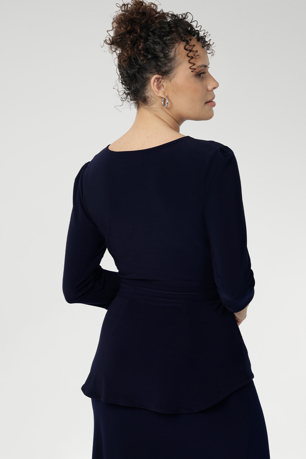 A fixed wrap top in Navy with 3/4 sleeves and a fixed wrap front. V-neckline top is the perfect corporate to casual top. Made in Australia for women size 8 - 24.