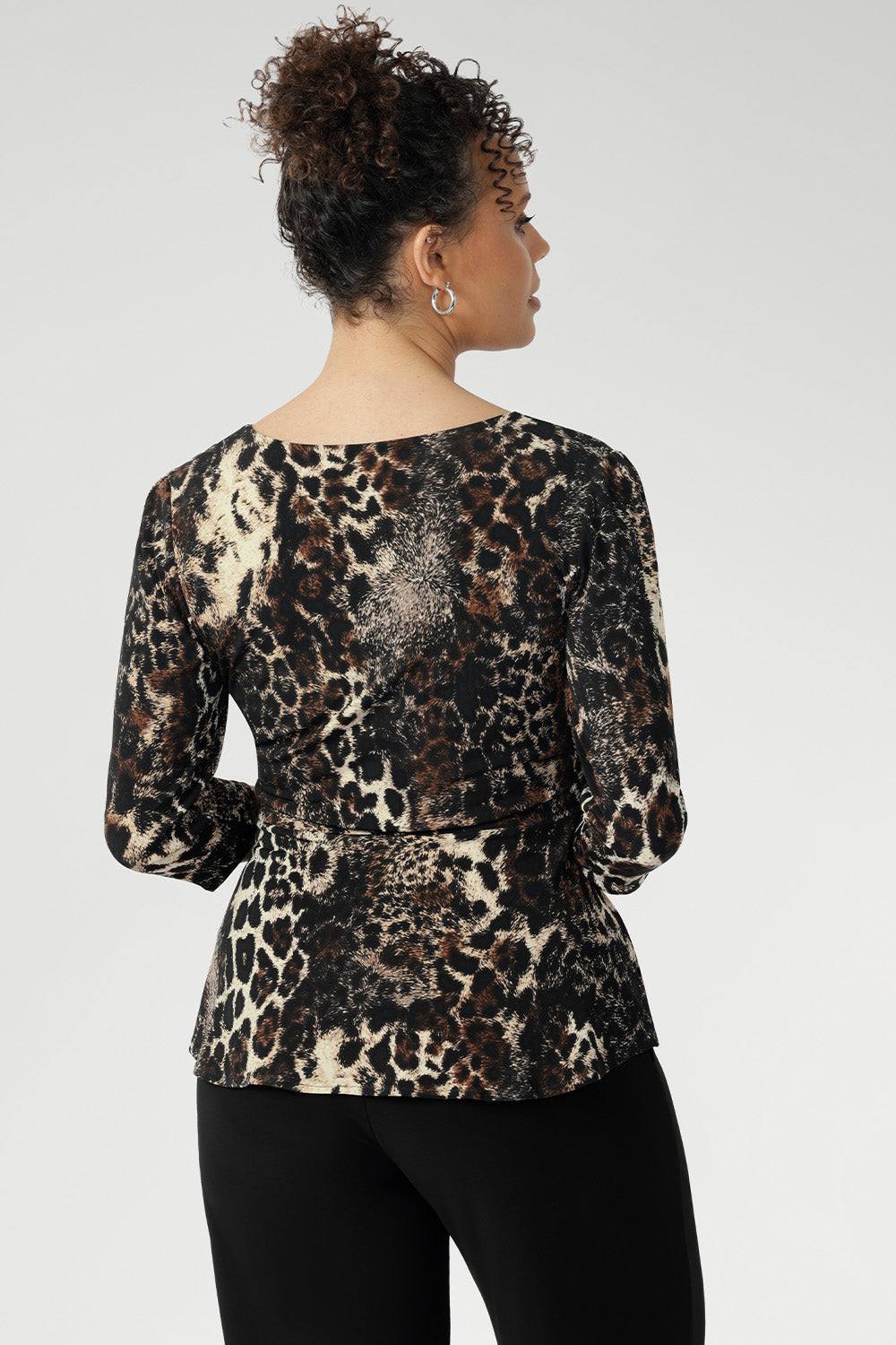 The Kyle Top in Panthera—a bold cheetah print—features a fixed wrap bodice that stays perfectly in place, offering the elegance of a wrap design without the need for constant adjustment.