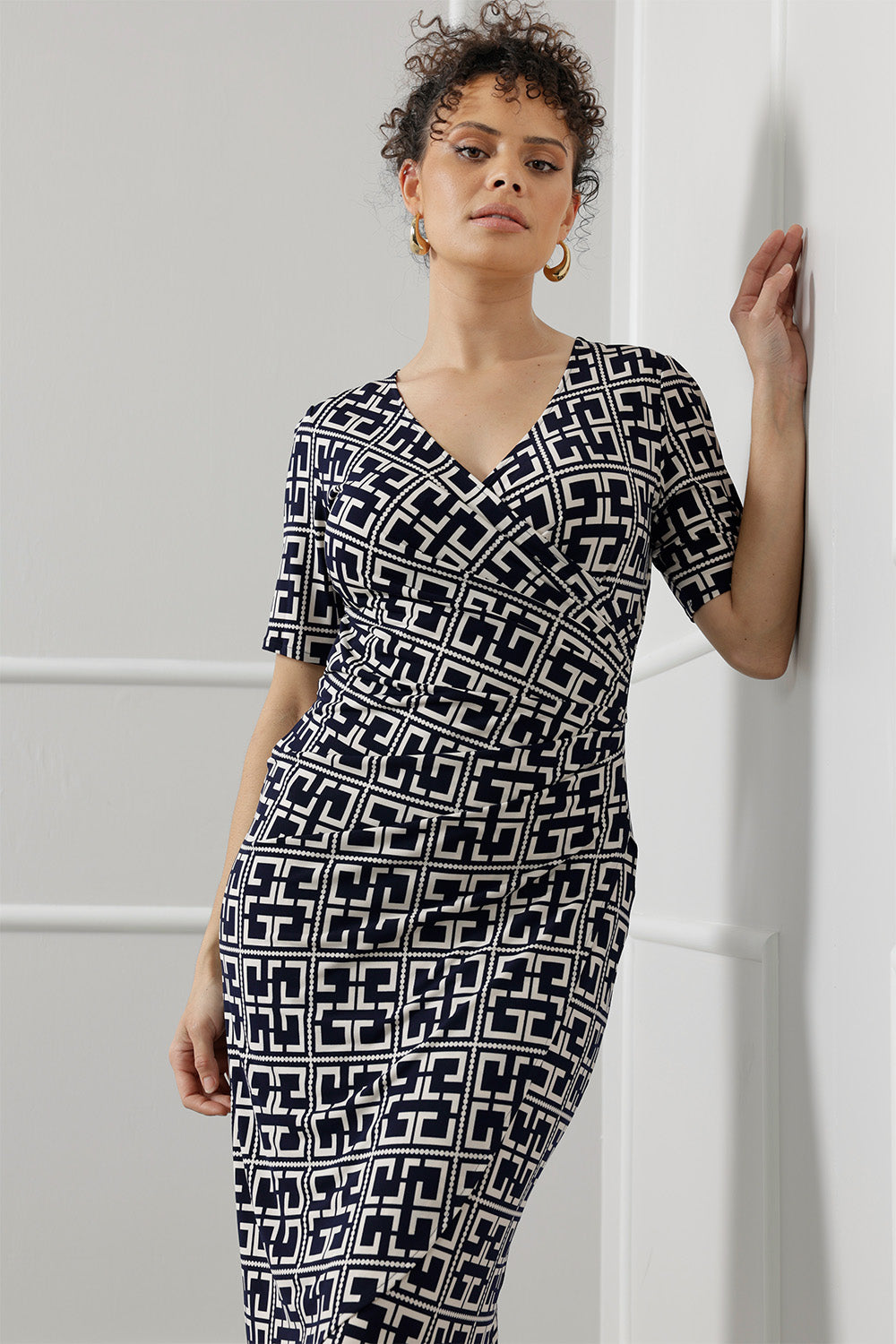 Elevate your wardrobe with the Leah Dress, expertly crafted from our signature dry-touch stretch jersey that delivers all-day comfort with a polished finish. Designed for seamless transitions from the office to evening events and weekend outings, this versatile dress features a flattering fixed wrap bodice, a sophisticated knee-length tulip skirt, and above-elbow sleeves that strike the perfect balance between coverage and style.