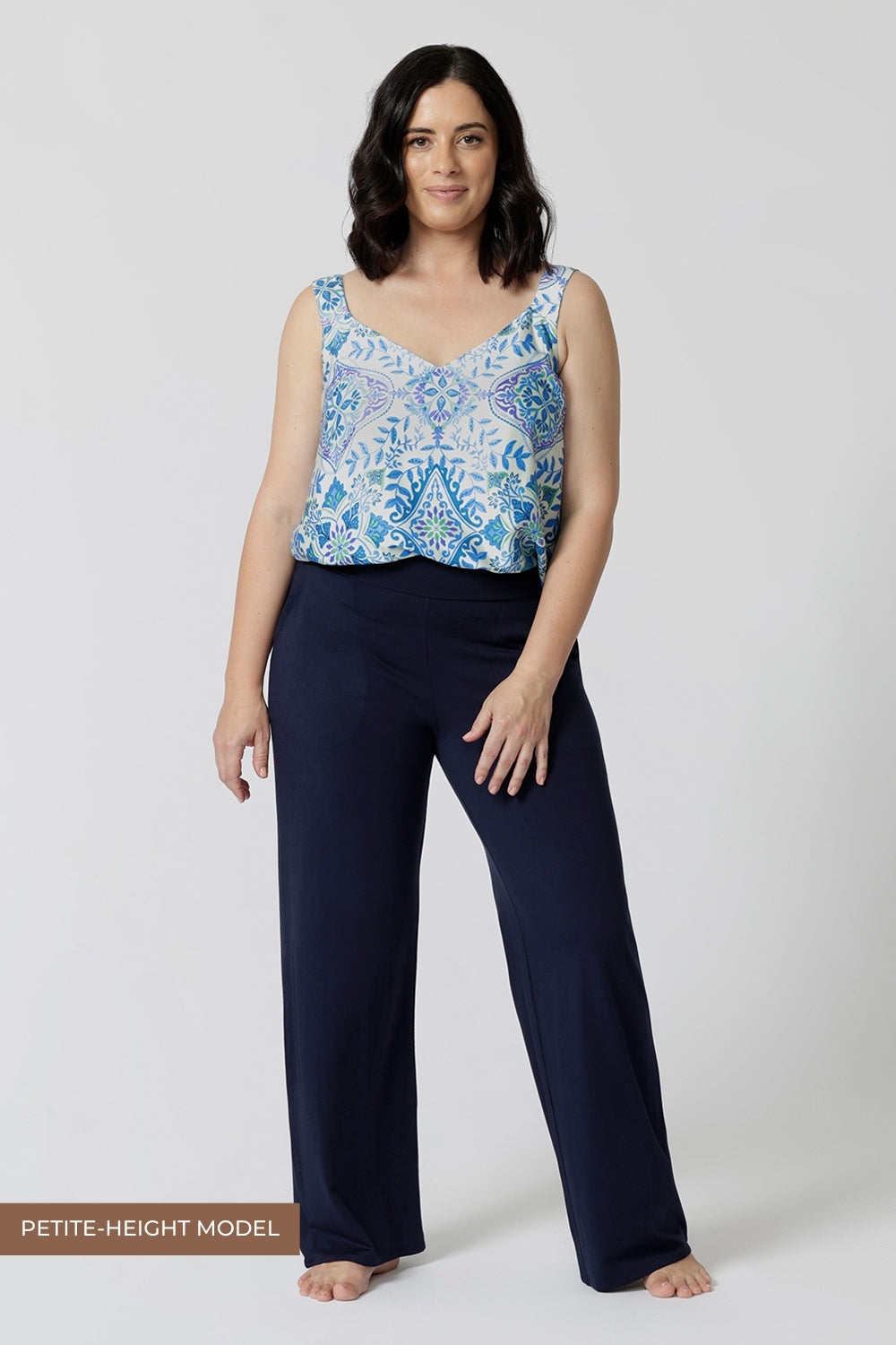 Showing good lounge pants for petite women, a size 10 woman wears straight, wide leg navy blue, plus size lounge pants in bamboo jersey with a blue and white print modal cami top. Breathable and thermo-regulating this is a good pyjama set for night sweats and hot flushes. Stay cool for summer nights with breathable sleepwear by L&F Australia in sizes 8-24.