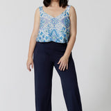 Showing good lounge pants for petite women, a size 10 woman wears straight, wide leg navy blue, plus size lounge pants in bamboo jersey with a blue and white print modal cami top. Breathable and thermo-regulating this is a good pyjama set for night sweats and hot flushes. Stay cool for summer nights with breathable sleepwear by L&F Australia in sizes 8-24.