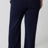 Back view of lounge pants for curvy women. A size 18 wears straight, wide leg navy blue, plus size lounge pants in bamboo jersey with a blue and white print modal cami top. Breathable and thermo-regulating this is a good pyjama set for night sweats and hot flushes. Stay cool for summer nights with breathable sleepwear by L&F Australia in sizes 8-24.