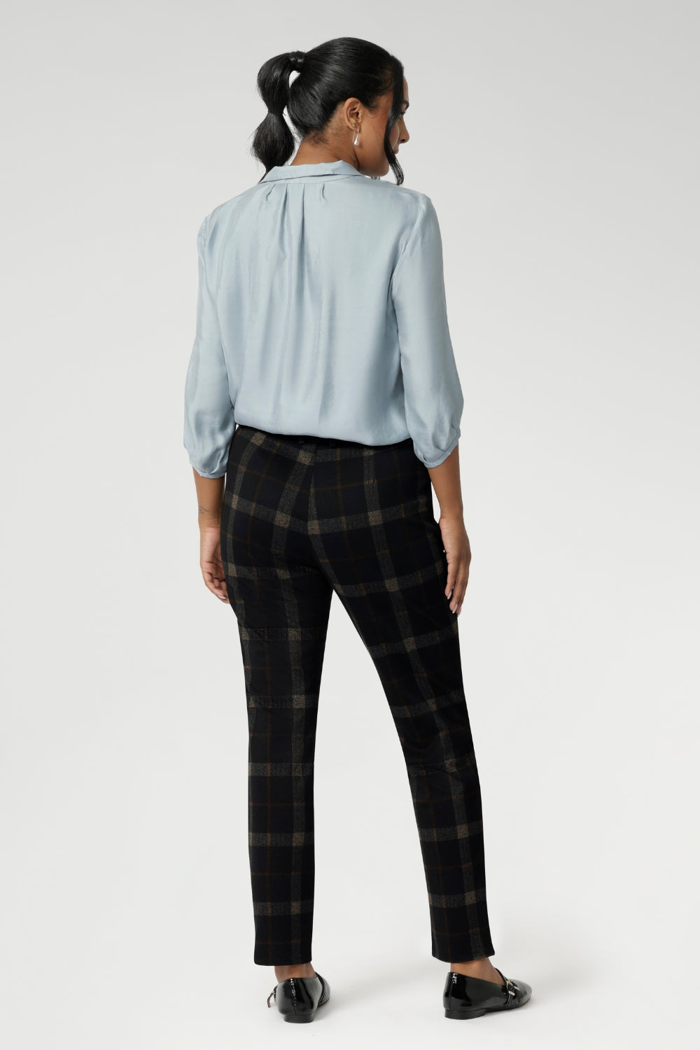 The tailored waistband features a fly fastening with a hook and bar closure for a clean front, while angled front pockets, back darts, and belt loops complete the look with refined detail.