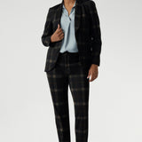 Lulu brings a sleek, modern edge to both workwear and smart-casual styling. This versatile pant is part of the Cocoa Plaid collection, a striking suiting range in a deep navy and graphite check. Size 10 woman wears her tailored pant with ice blue coloured blouse and matching plaid blazer.