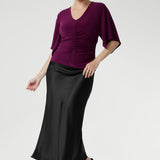 The Luna Top is expertly crafted from our signature dry-touch stretch jersey, offering a perfect balance of professional style and all-day comfort. This elegant top features a flattering V-neckline that adds a touch of sophistication, while the unique handkerchief sleeves bring a modern, feminine edge to your wardrobe. Designed with subtle bust darts for enhanced fit and a clean straight hemline for a polished silhouette.